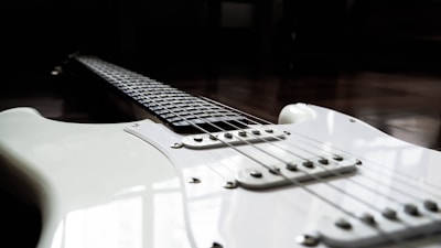 Close-up of a classic electric guitar with intricate fretboard inlays.