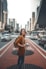 woman standing on middle of road