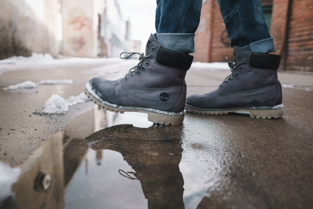 person wearing pair of gray Timberland work boots