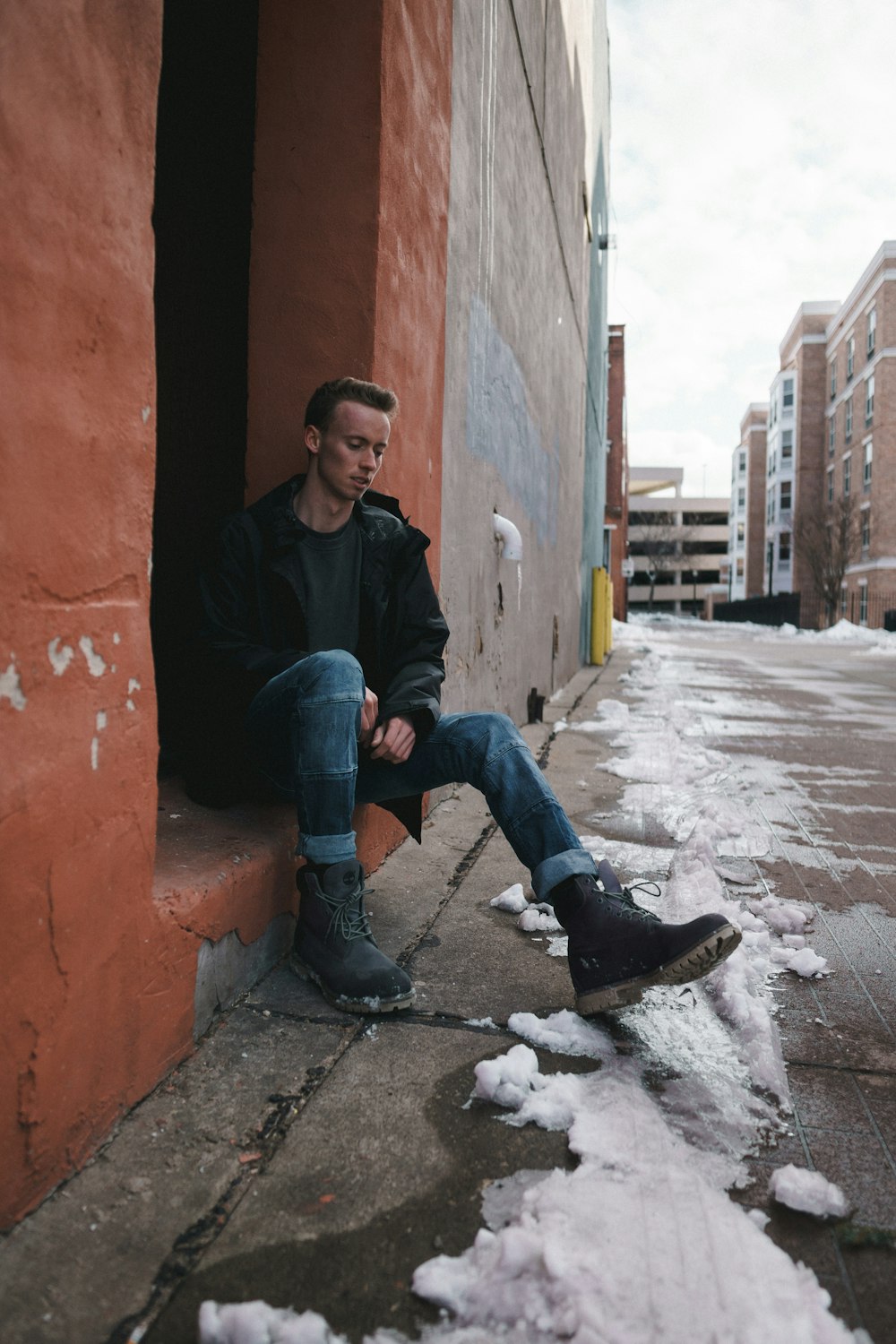 man sitting on brick