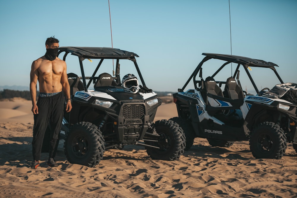 person standing beside black ATV