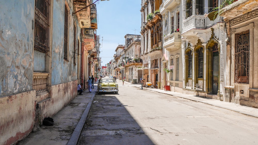 yellow car parked near painted concrete houses