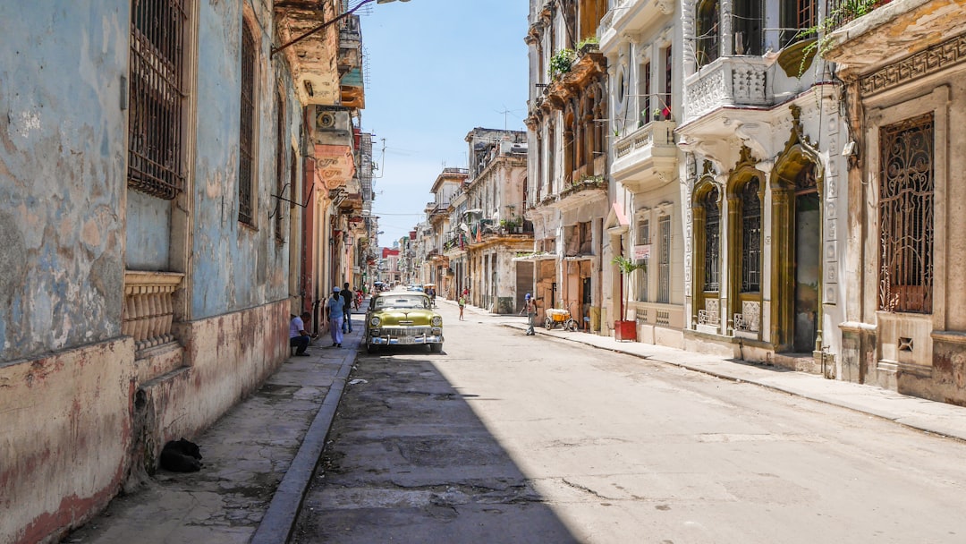 yellow car parked near painted concrete houses,