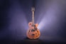 brown and black jazz guitar with dim light