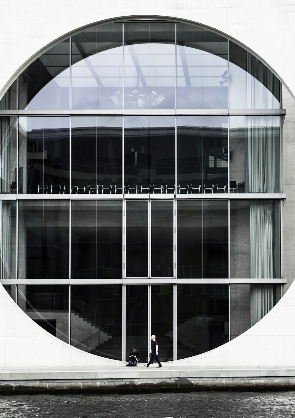 person beside clear glass building