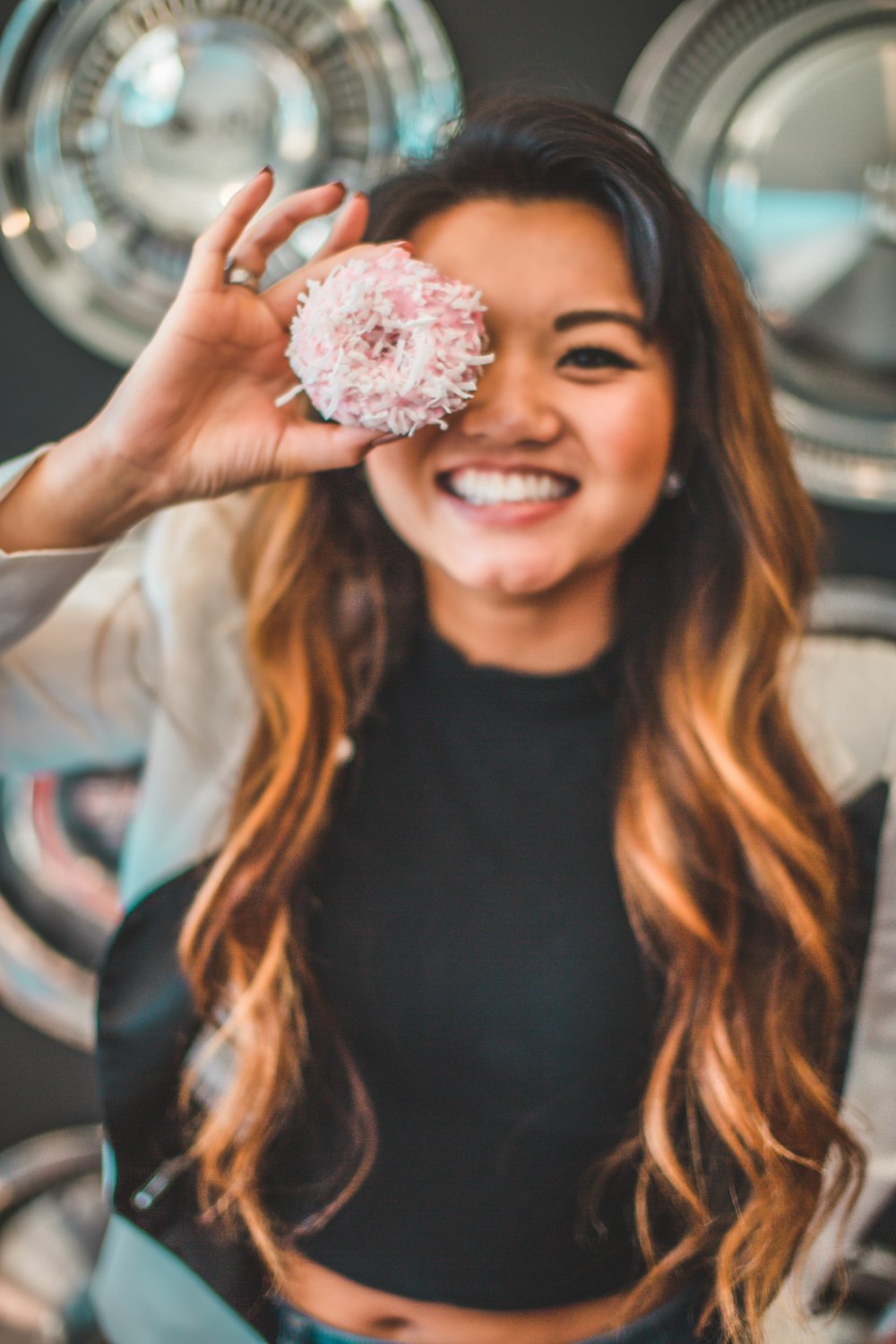 woman holding round strawberry pastry