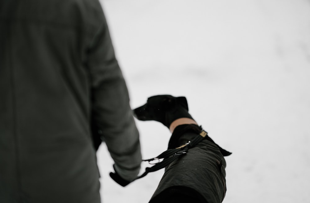 man beside black dog during daytime