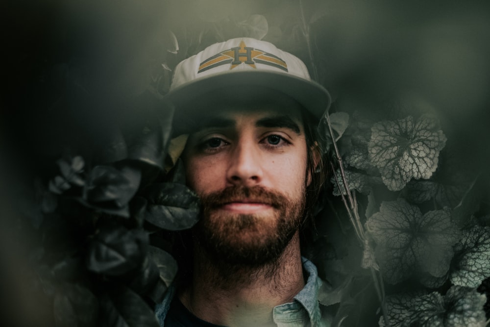 shallow focus photography of man hiding in green plants