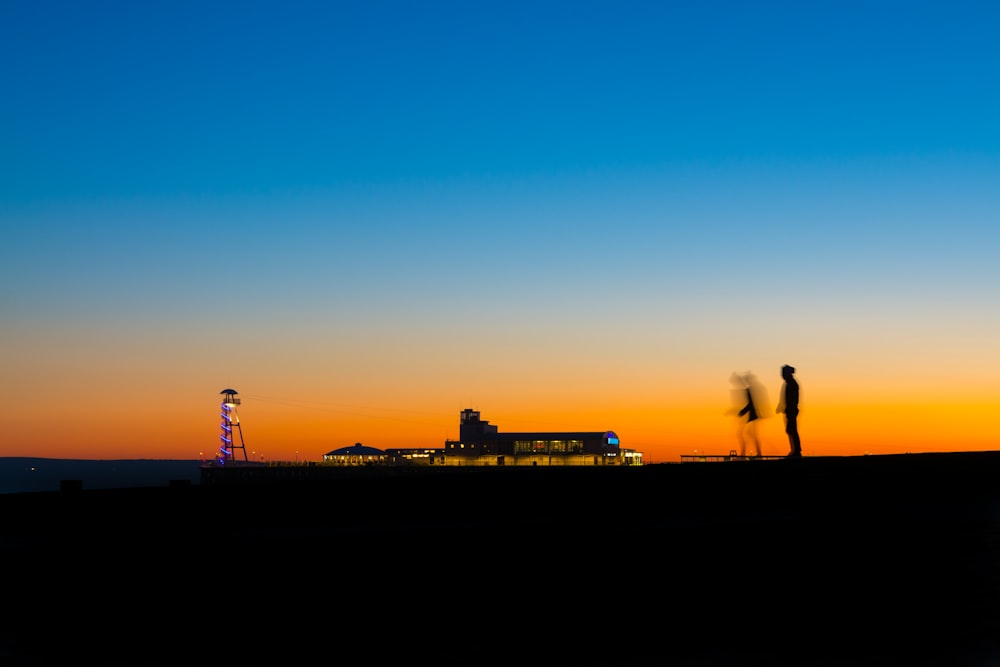 silhouette of person under blue sky