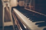 a close up of a piano with a person in the background