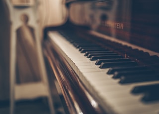 a close up of a piano with a person in the background