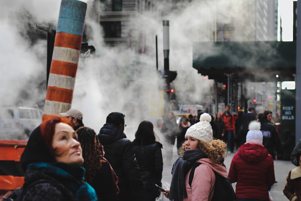 people standing near teal concrete building