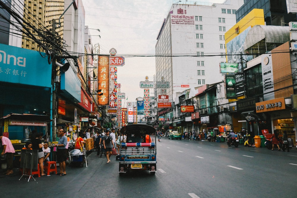 people walking at the road outside the buildings