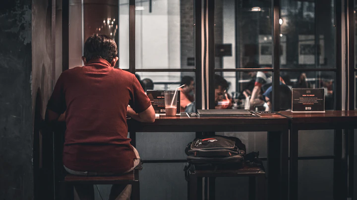 Person working alone at a café bar