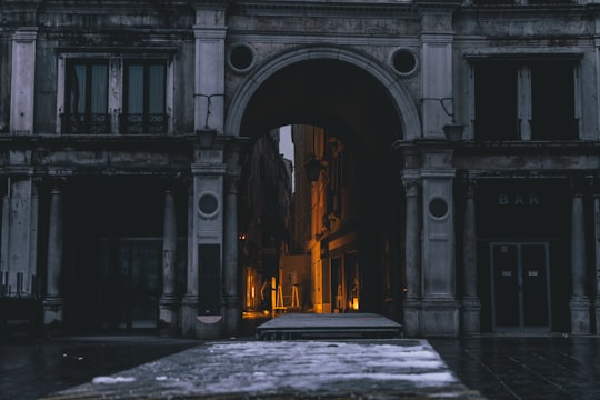 gray concrete arc gateway photography in St Mark's Clocktower Italy