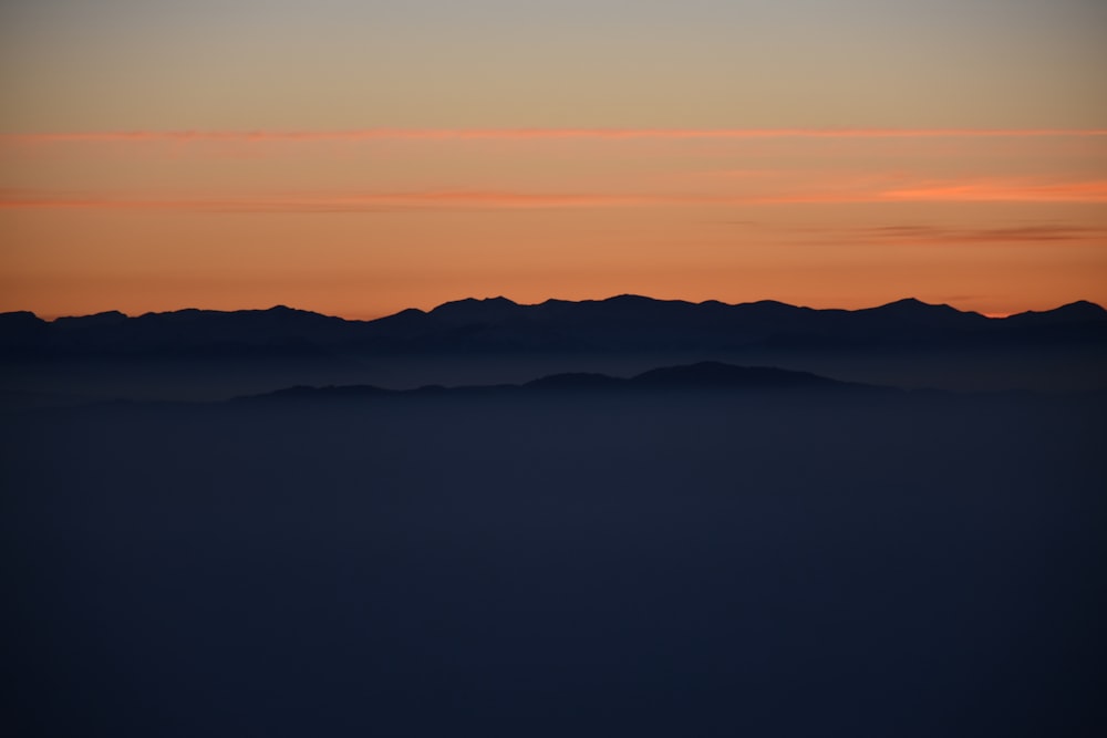 silhouette of mountains during golden hours
