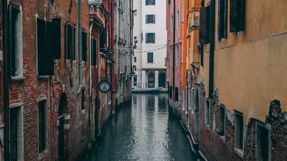 two orange buildings near canal