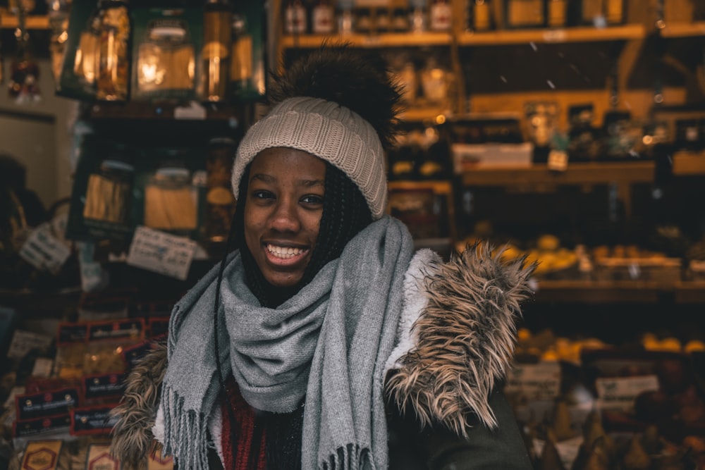 smiling woman standing inside deemed room