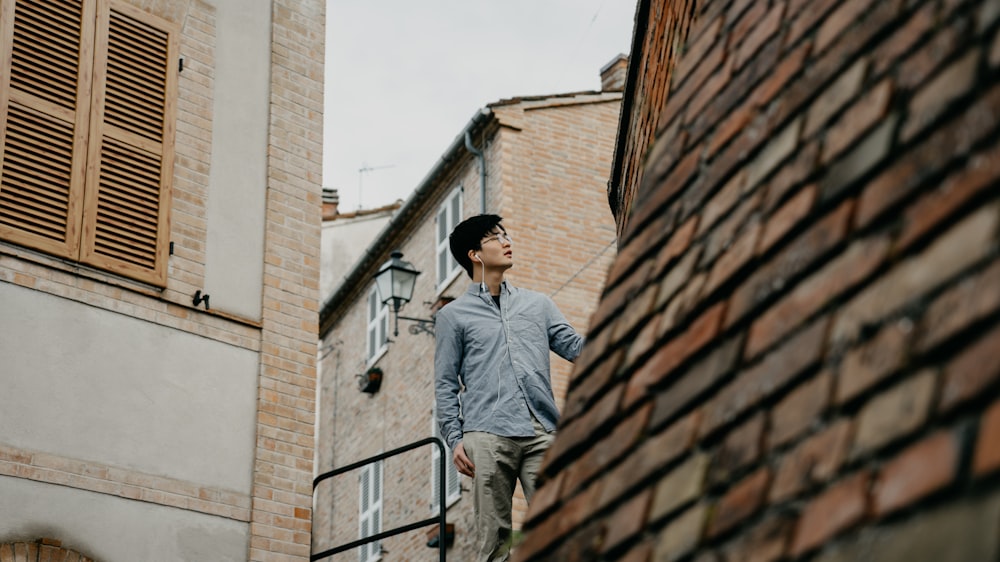 man standing near brown concrete house