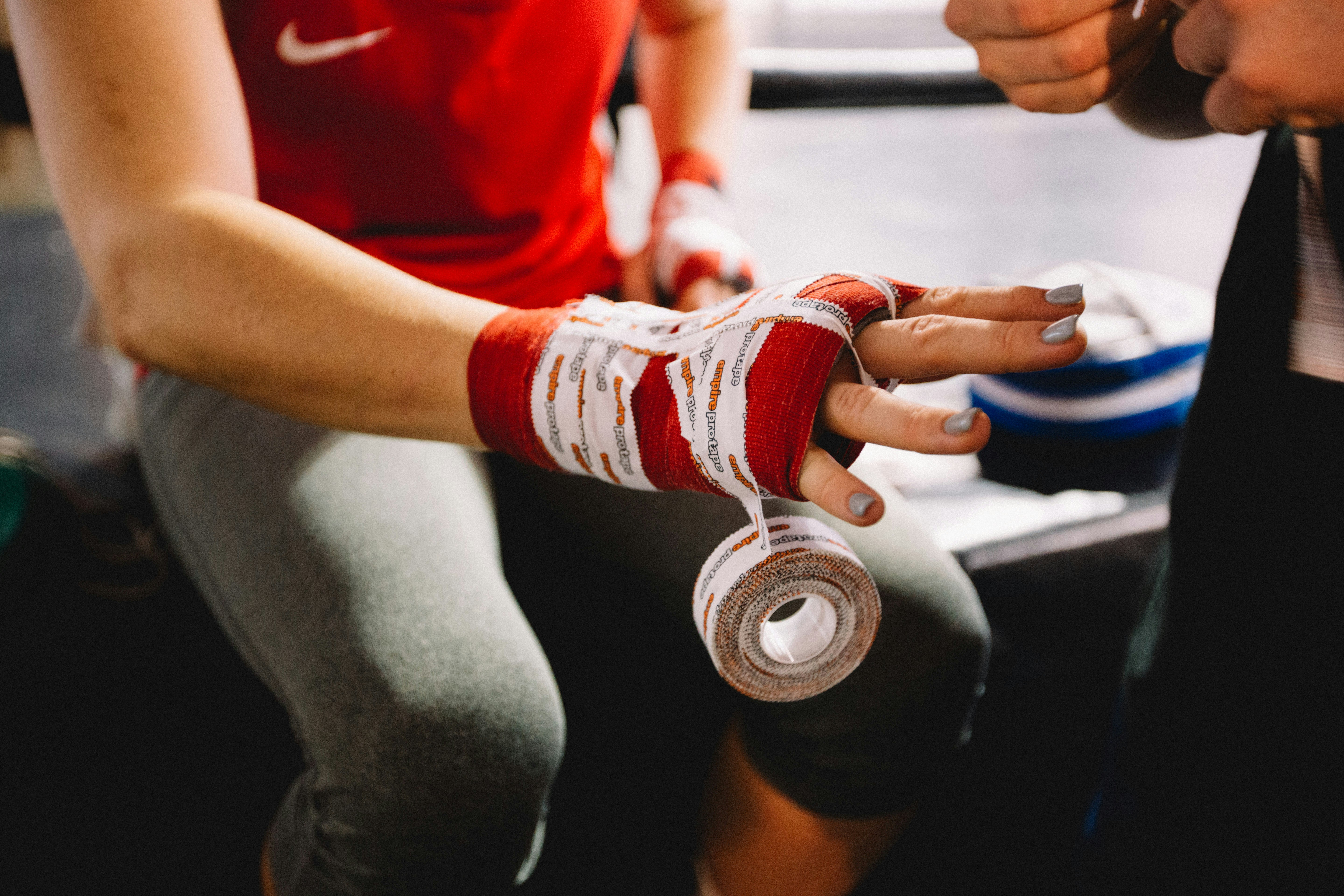 Female boxer getting ready to fight. Love the detail of her finger nails whilst getting wrapped up to punch! Lookout!