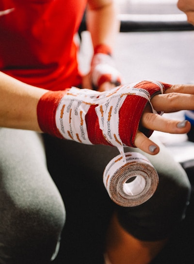 person wrapping bandage