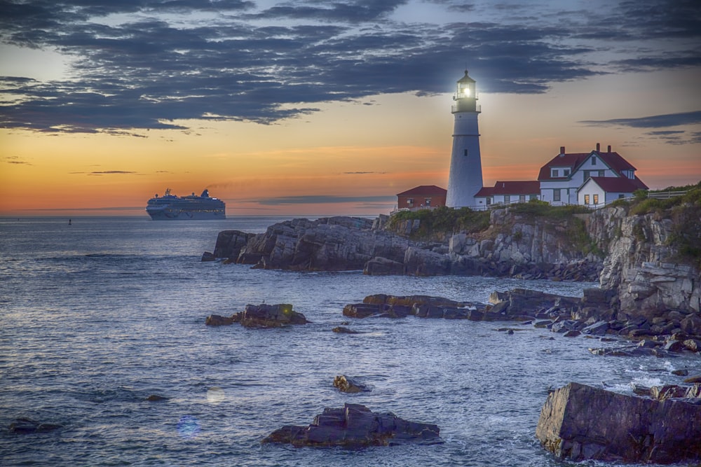 red and white lighthouse on cliff