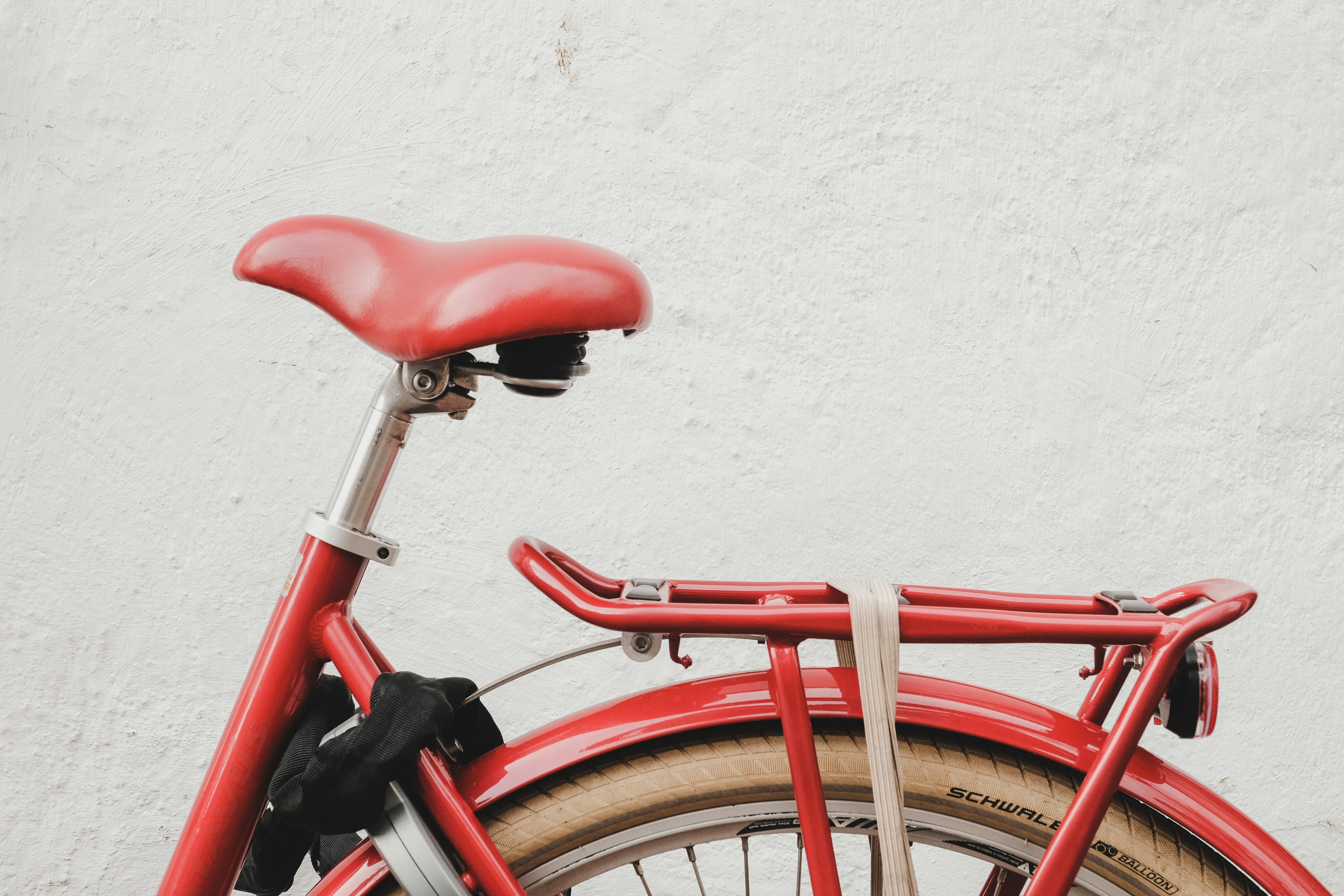 red bicycle near white wall