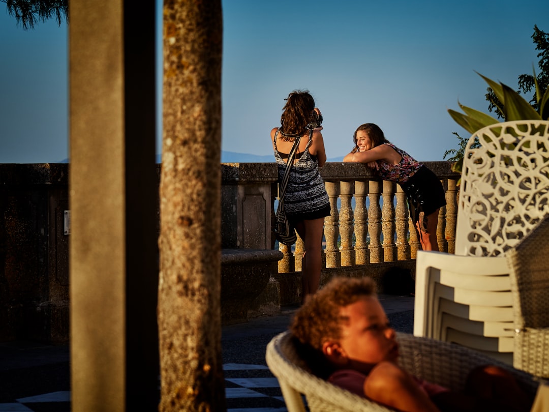 woman taking photo at balcony pedestal