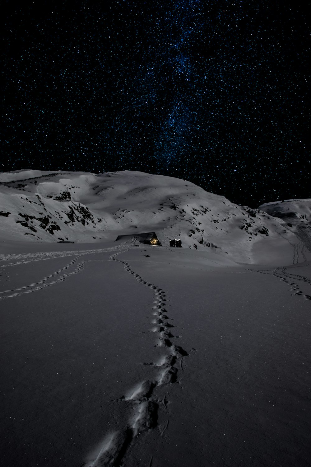 house on mountain in snow