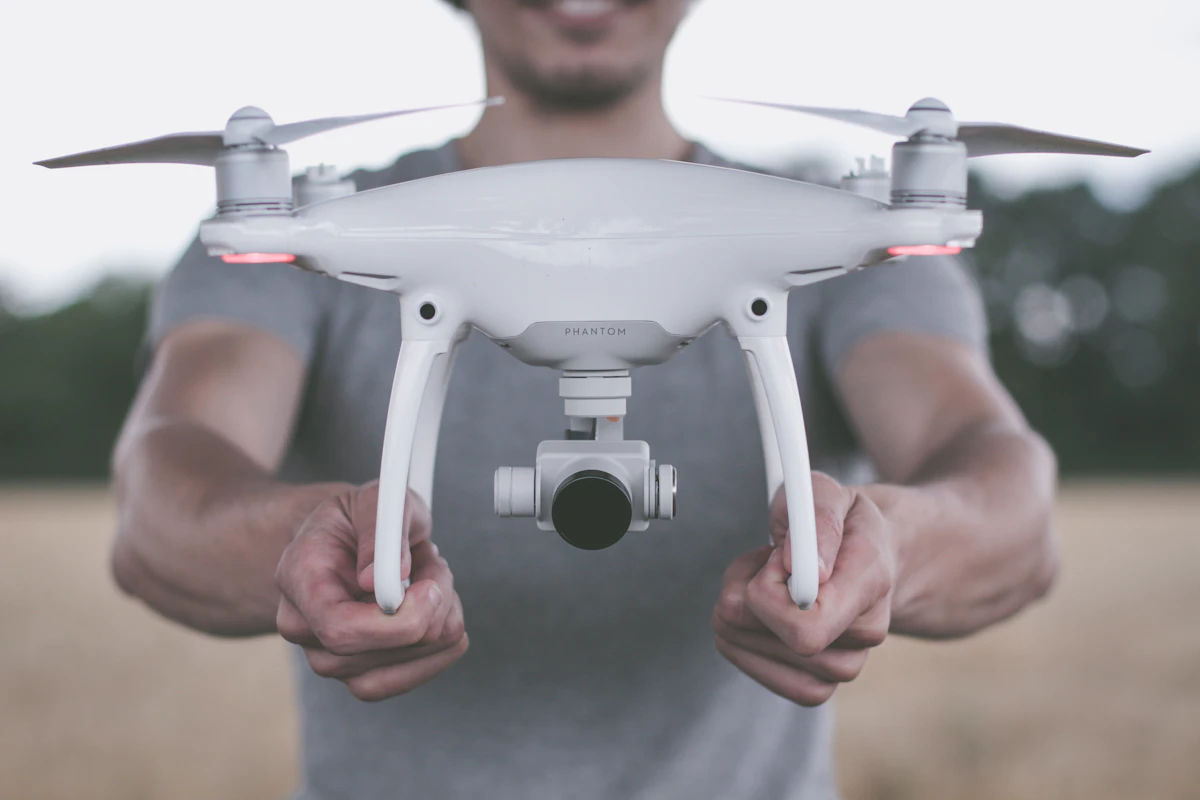 A person holding a quadcopter drone