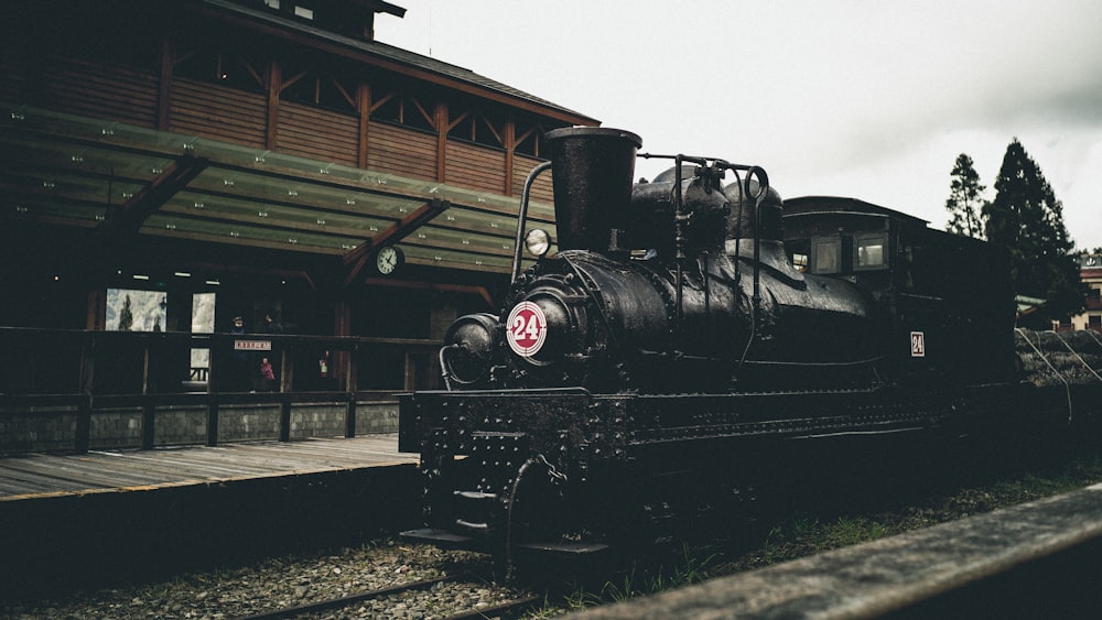 black train near brown wooden establishment