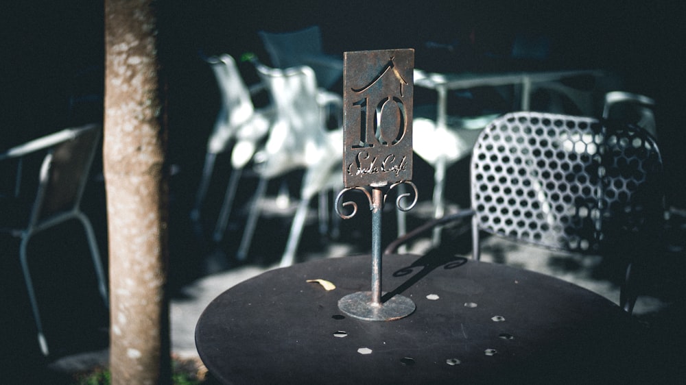 gray metal table stand on black surface