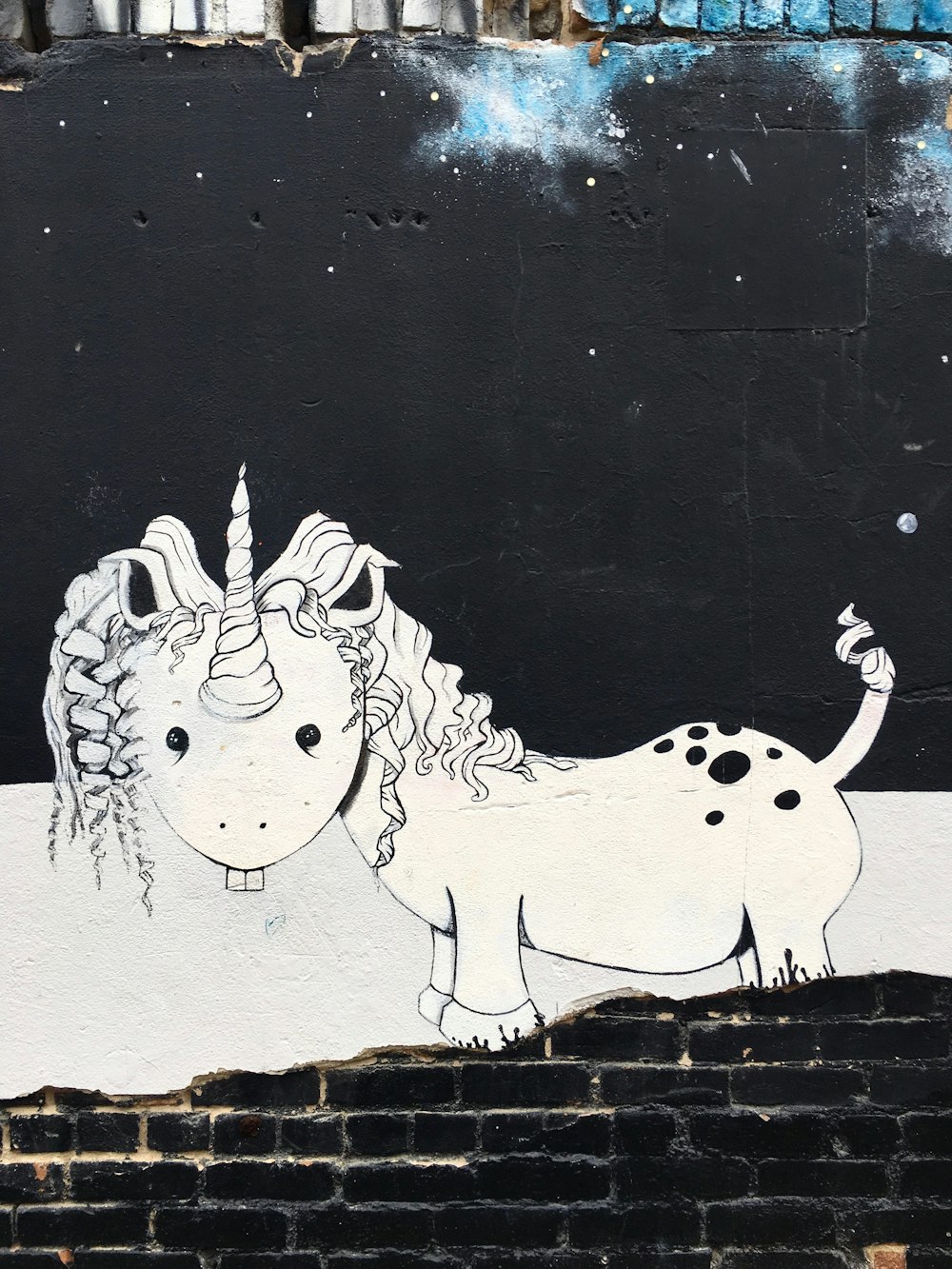 white and black unicorn mural