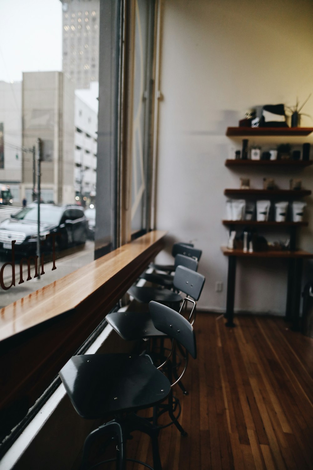 five black highchairs near window