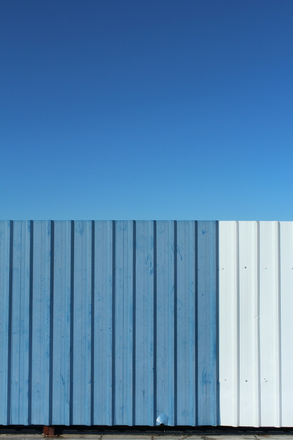 blue and white metal fence