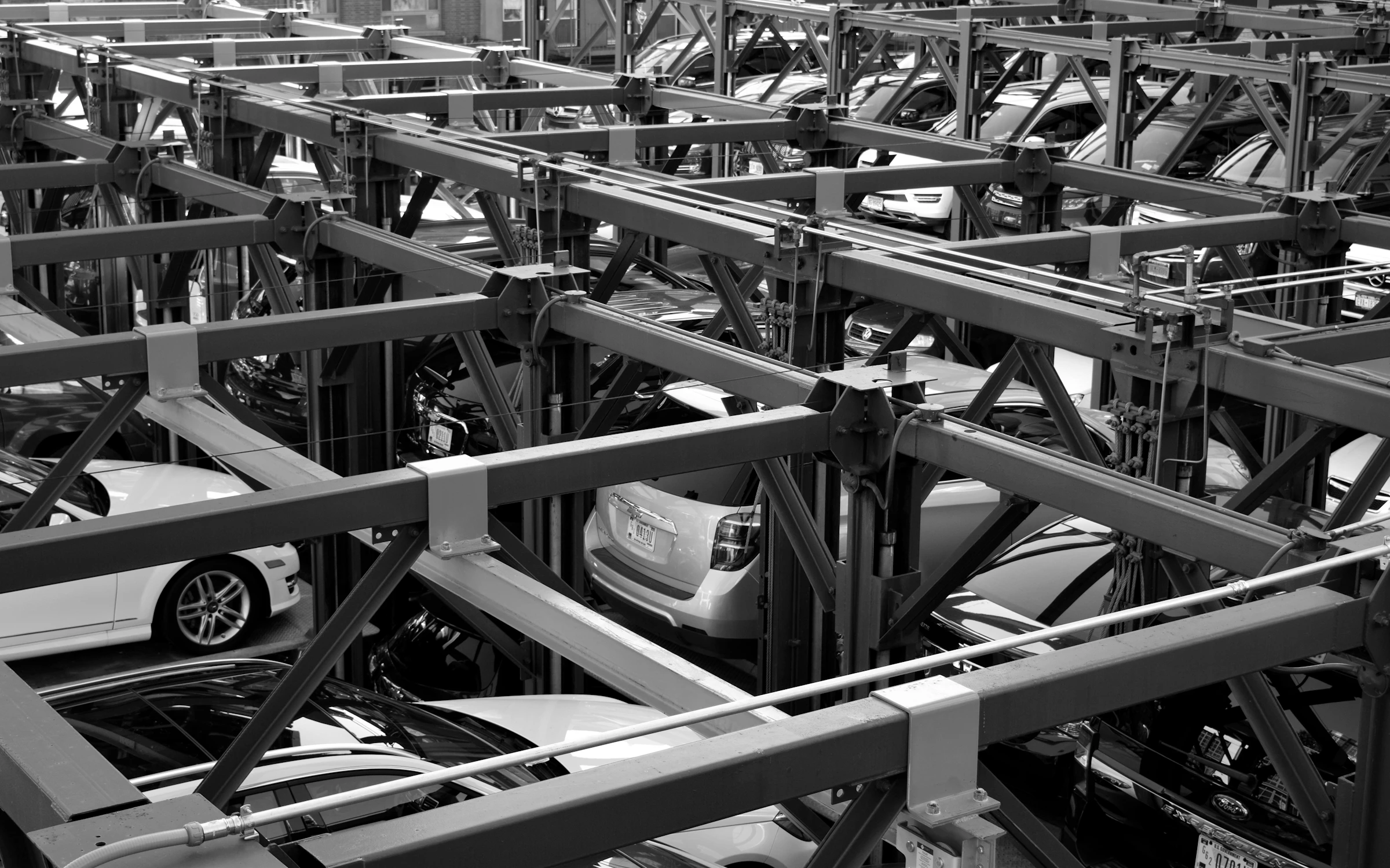Finished vehicles stacked in a multi-level transport rack at an automotive plant