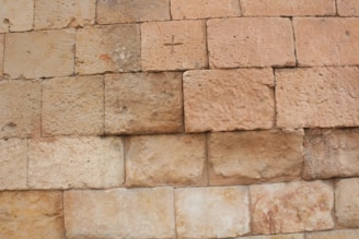 Close-up of the chapel’s ancient stone walls showing the texture and signs of restoration.