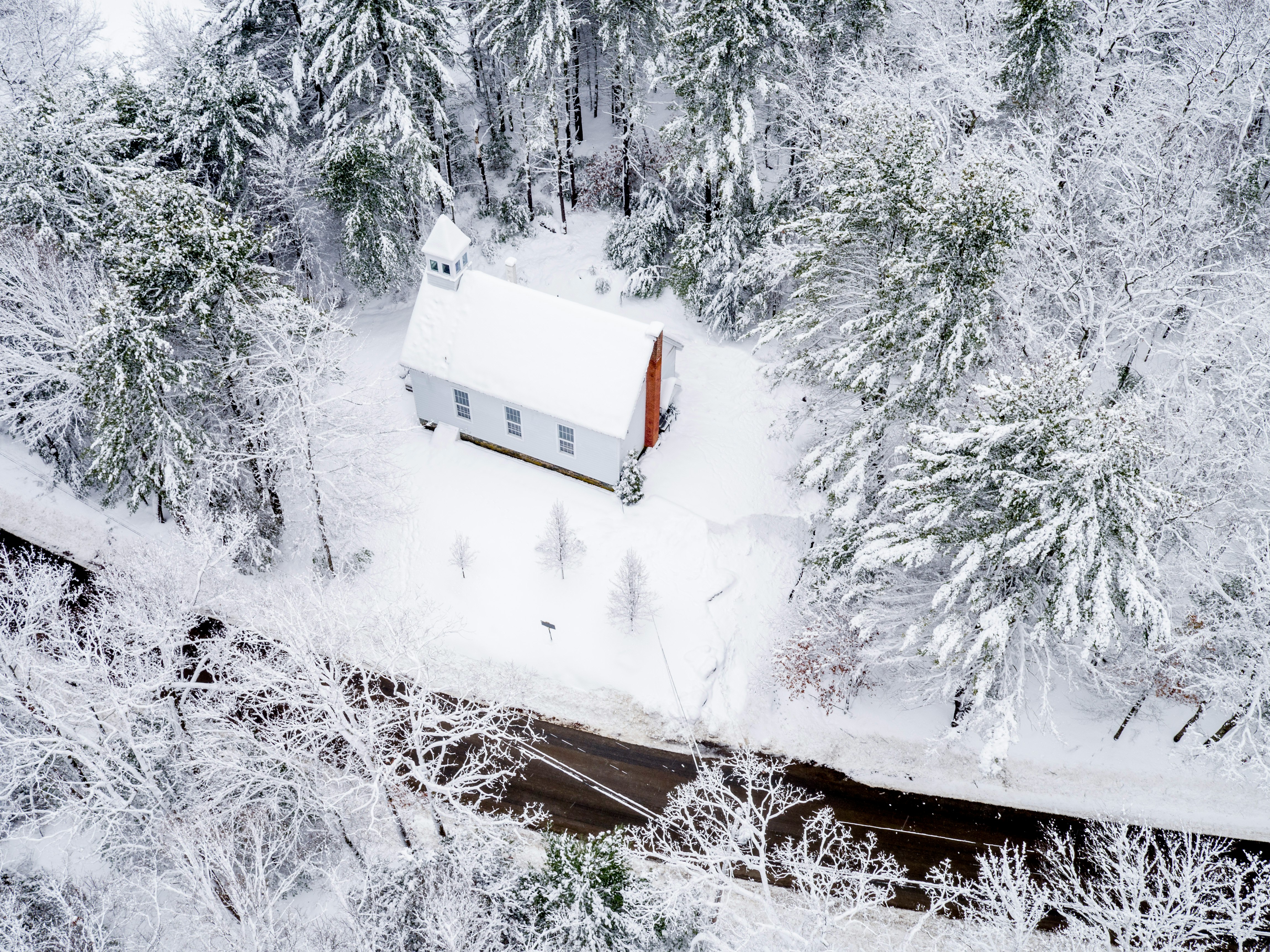 aerial photo of snow-covered building and trees