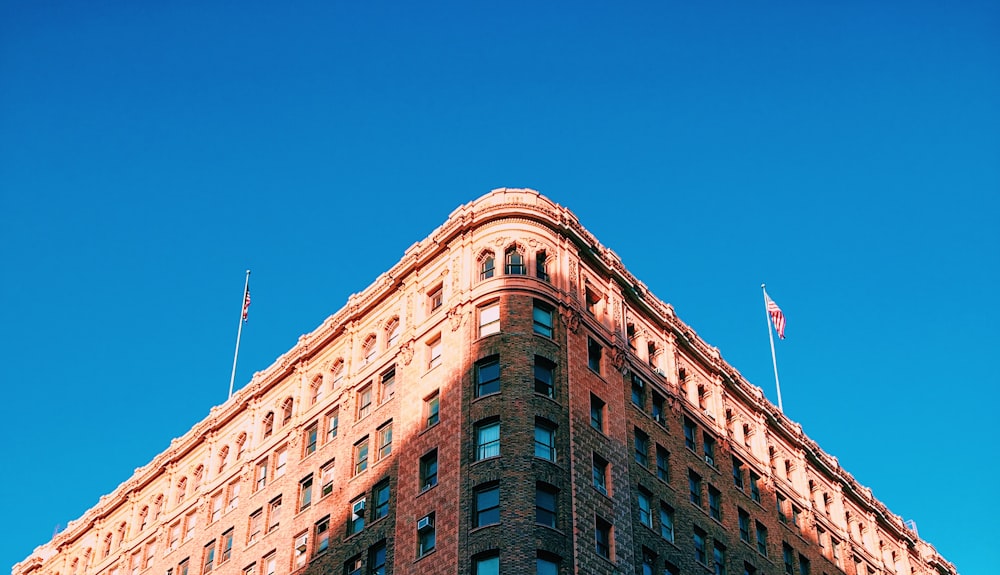 brown concrete building under clear blue sky at daytime