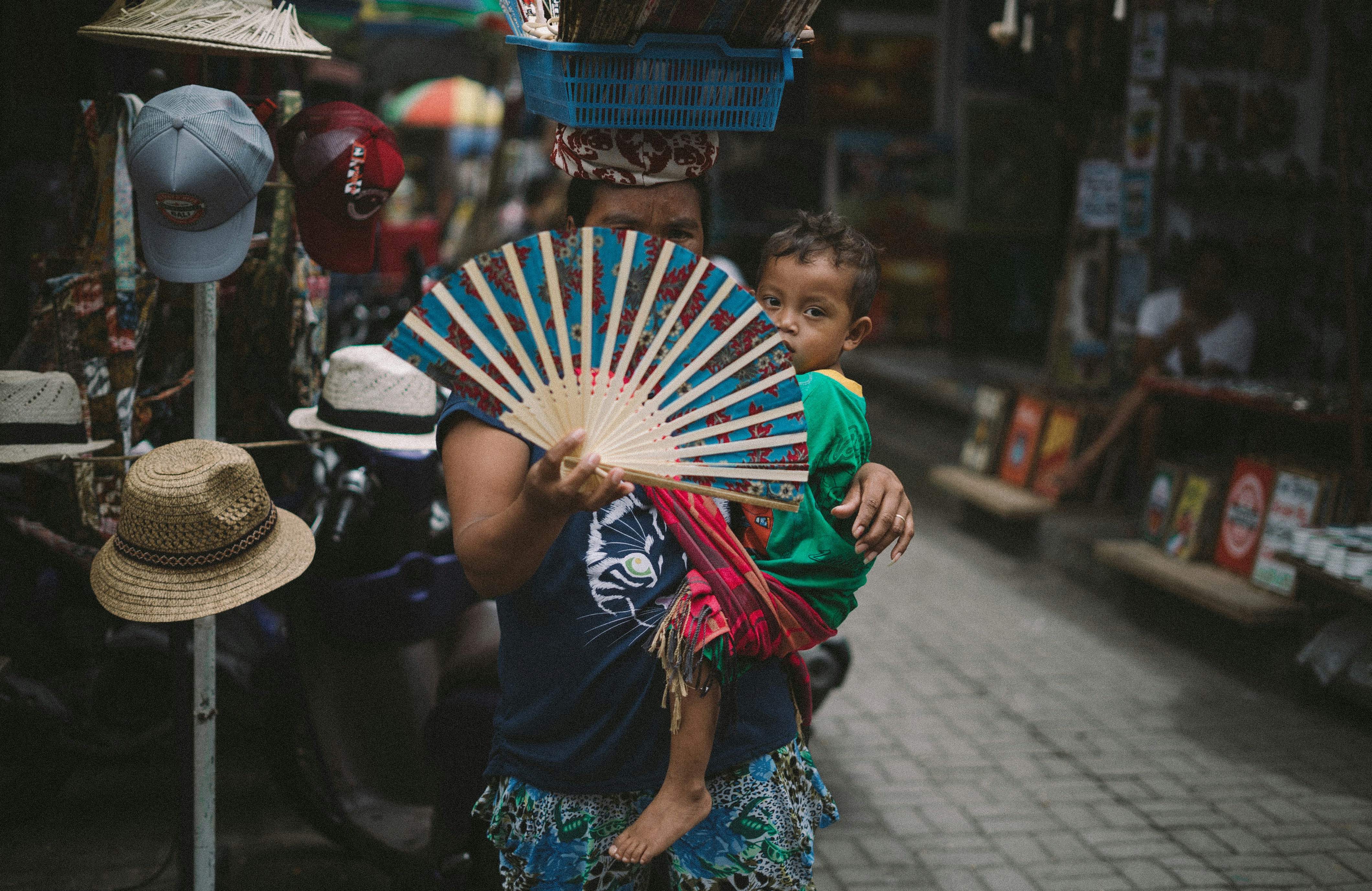 This woman was selling fans in the middle of Ubud market with her kid hanging on her shoulder and a load of other fans on her head