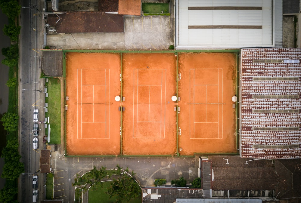 an aerial view of a tennis court and a parking lot