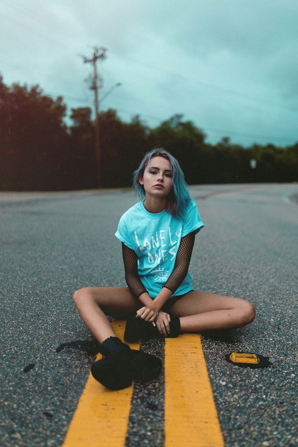 woman sitting on road