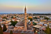 A panoramic view of Aden city skyline at sunset, symbolizing local focus.