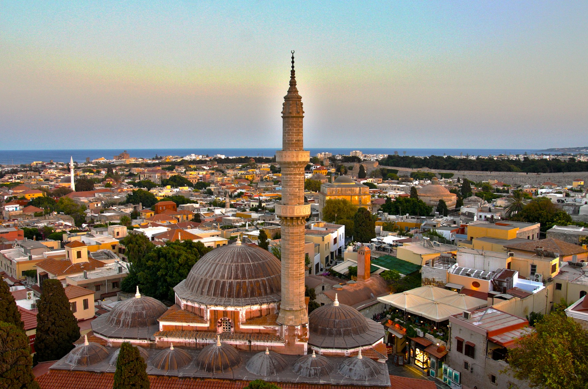 woman wearing yellow long-sleeved dress under white clouds and blue sky during daytime