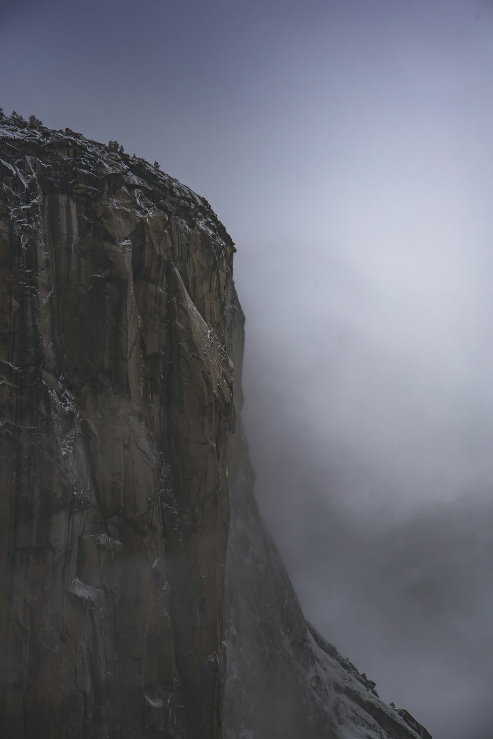 brown rocky mountain under white cloudy sky photo