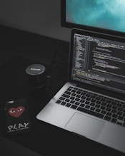 MacBook Pro open near black Canon mug