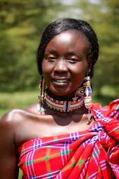 woman in red and brown top smiling