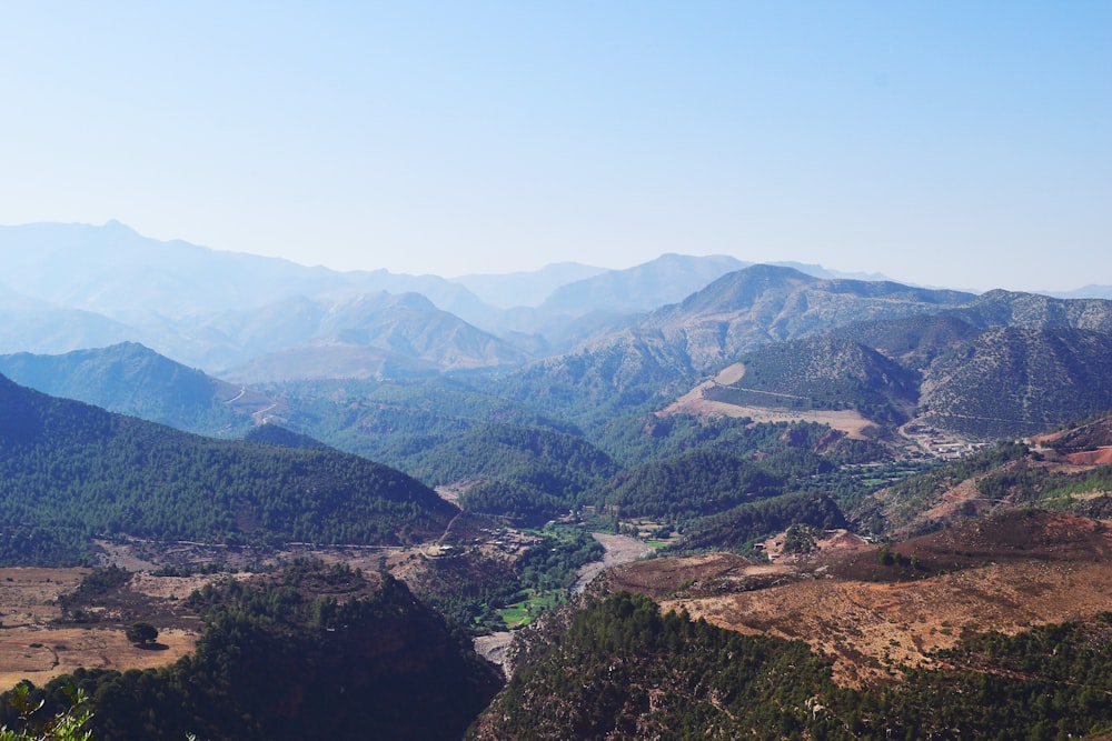 green and brown mountains under blue and white sky at daytime