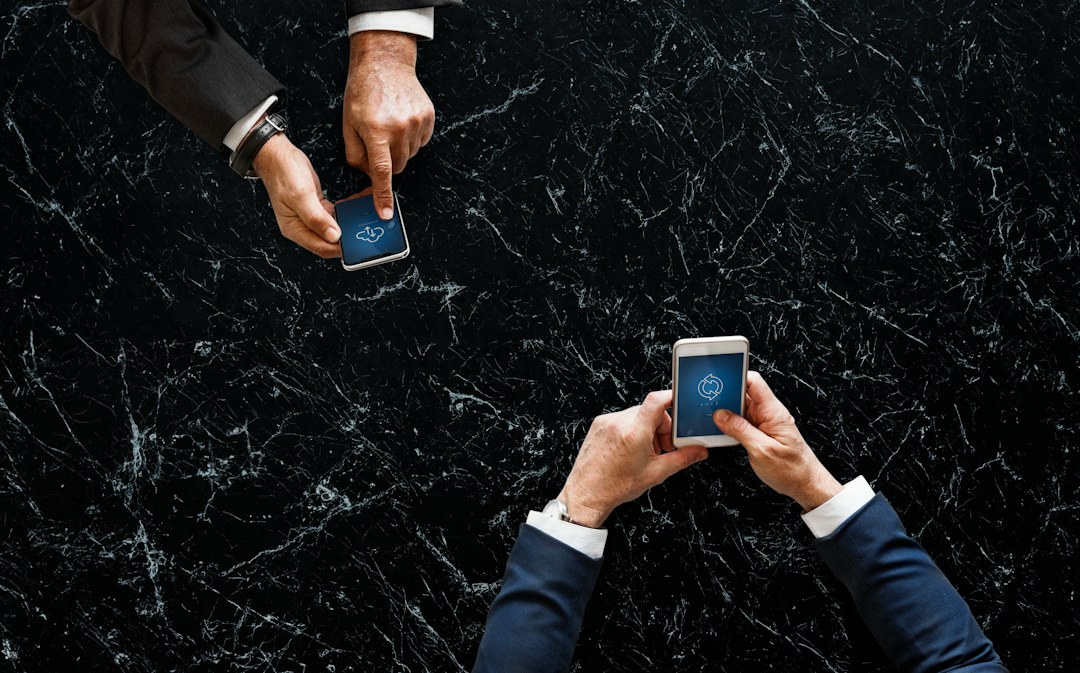 two men operating smartphones