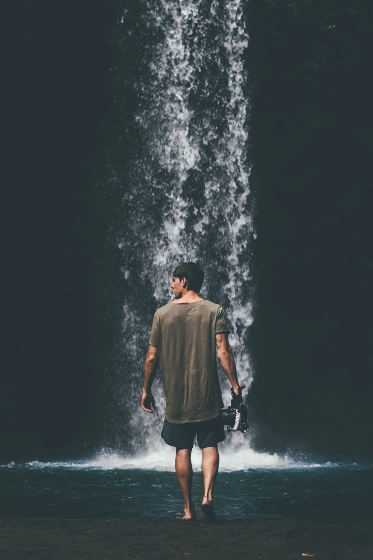 Visitor walking near Tibumana Waterfall in Bali